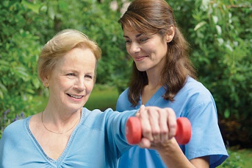 A caregiver helping a client exercise.