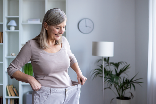 happy-senior-woman-examines-her-weight-loss-(1).png