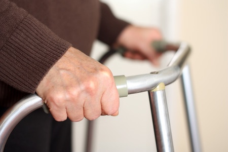 edlerly woman's hands on walker