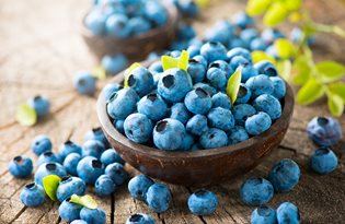 bigstock-Blueberry-on-wooden-table-back-97797563.jpg