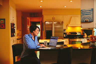 A family caregiver searching on her computer for an in-home care agency.